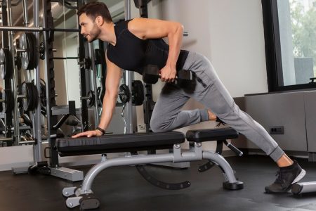 homem fazendo exercício com um halters em um banco de musculação